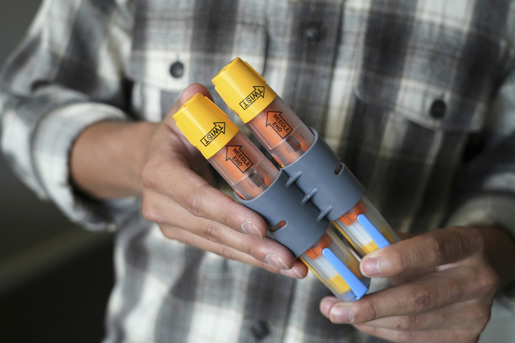 Braxton Kimura shows his EpiPens at home in San Jose, Calif.