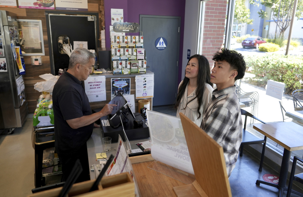 Braxton Kimura, right, orders food with his mother Carol Kimura at Vitality Bowl on Wednesday, Aug. 13, 2025, in San Jose, Calif.