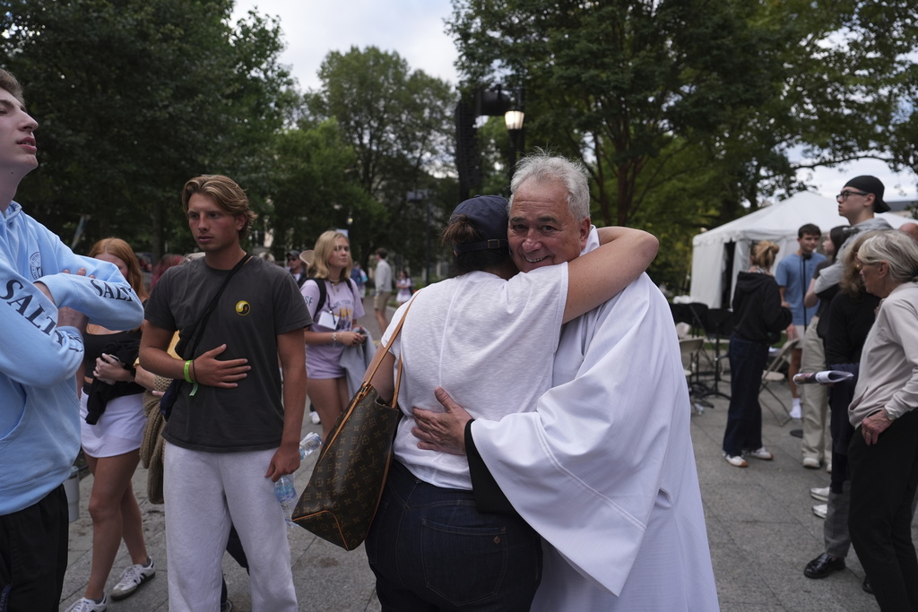 Villanova University President Father Peter M. Donohue comforts after an active shooter was reported