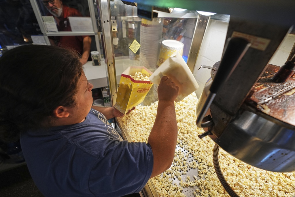 Mason Butz prepares a bag of popcorn in the refreshment stand at the Shankweiler Drive-In