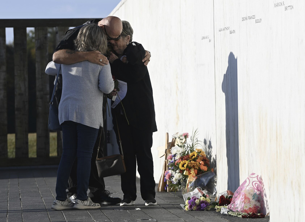 Karen Bingham, right,, who lost her son Mark Bingham in the Sept. 11, 2001 attacks, is shown with family members at the Wall of Names during Flight 93 National Memorial