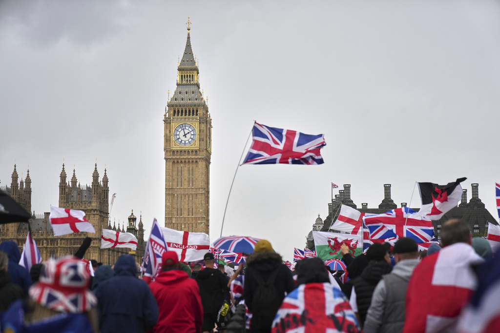 Demonstrators take part in the Tommy Robinson-led Unite the Kingdom march and rally near Westminster, London