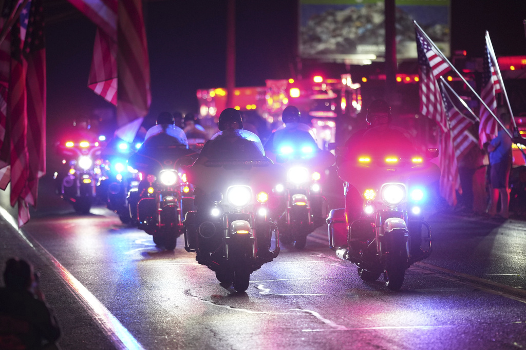 Police officers ride during a procession Wednesday, Sept. 17, 2025, in Spring Grove, Pa., after multiple police officers were shot and killed. 