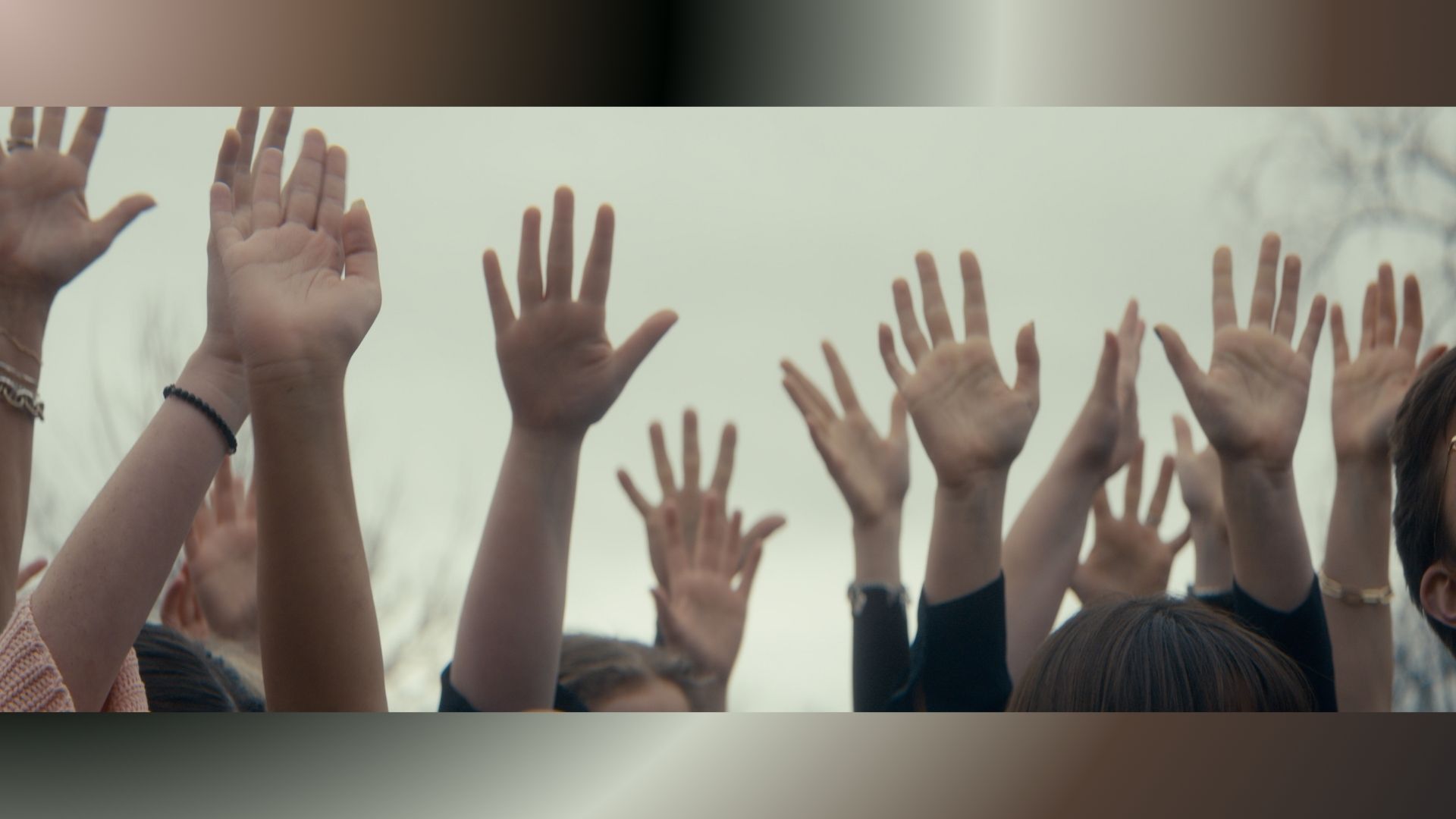 Hands raised in Angel Studios