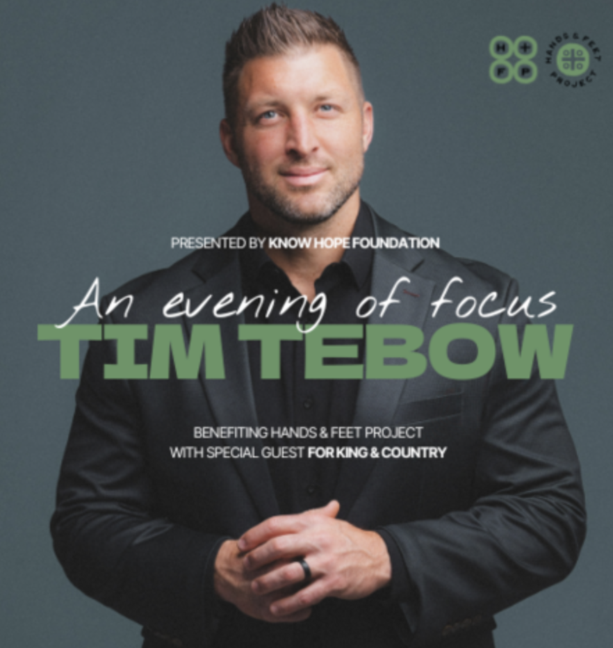 Man smiling with black sport coat and black shirt