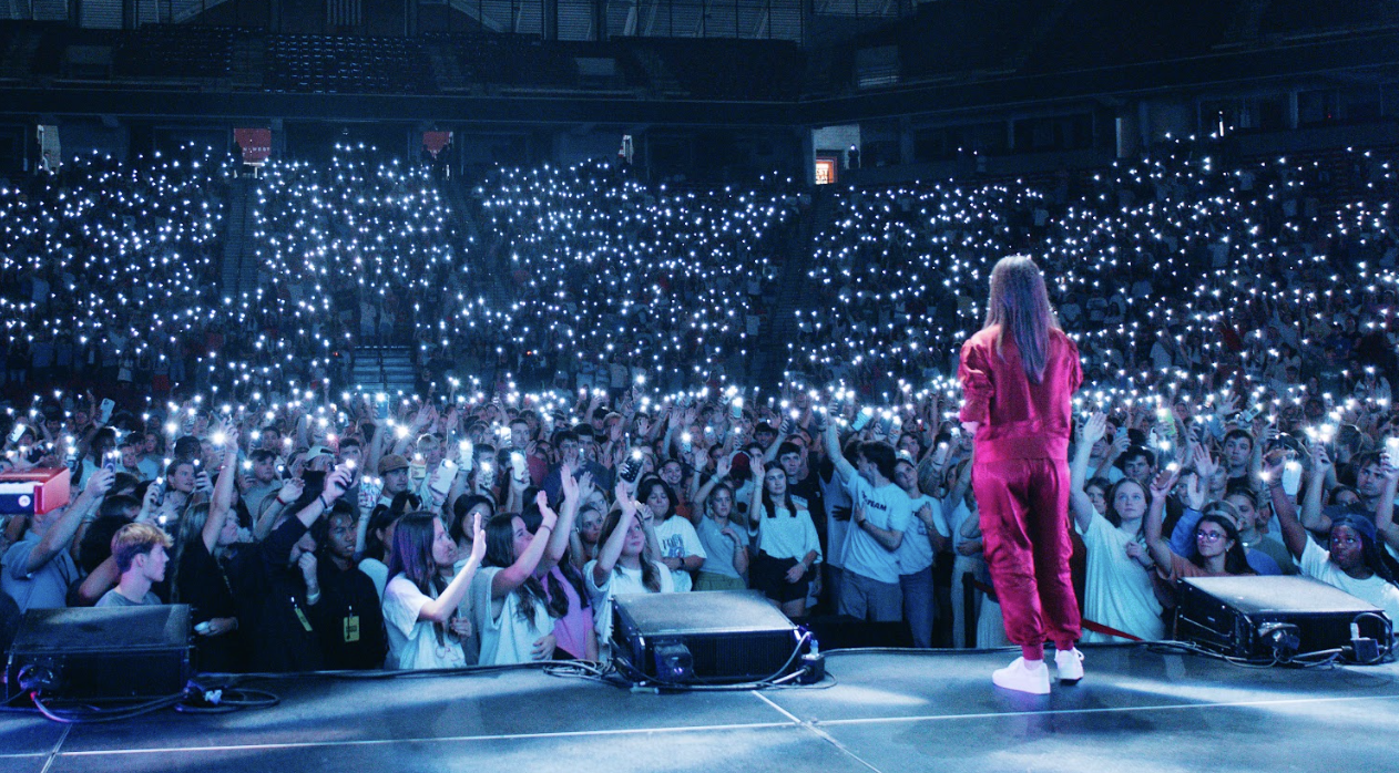 Tonya in a red outfit in front of a huge crowd