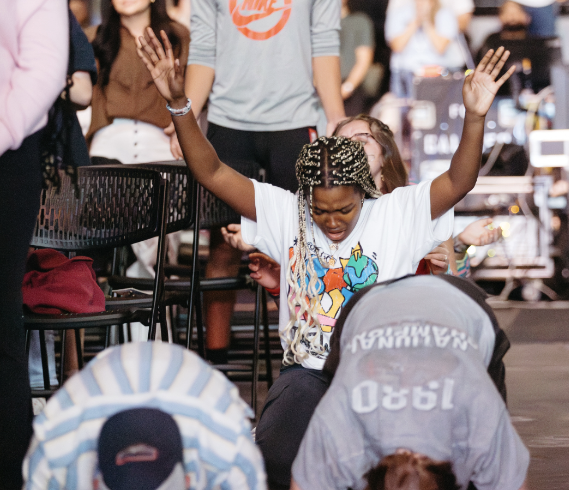 Students on their faces, one with hands raised