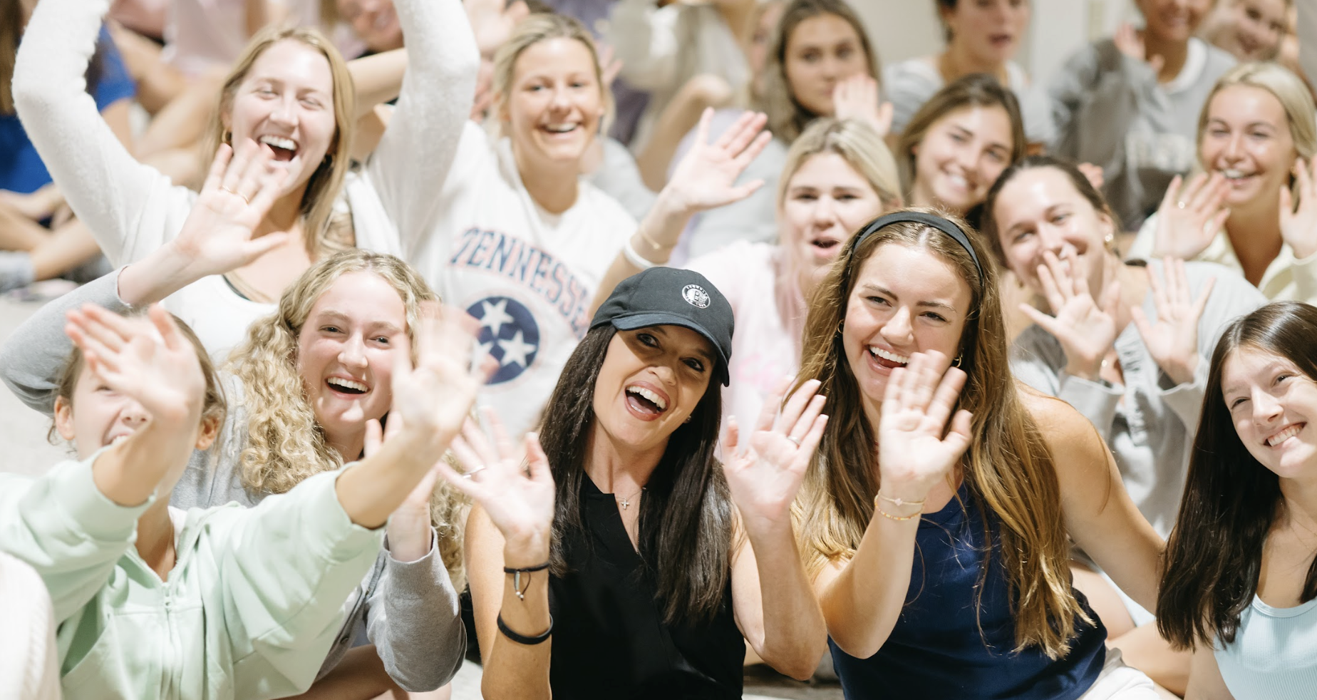 Tonya in the middle of a group of female college students
