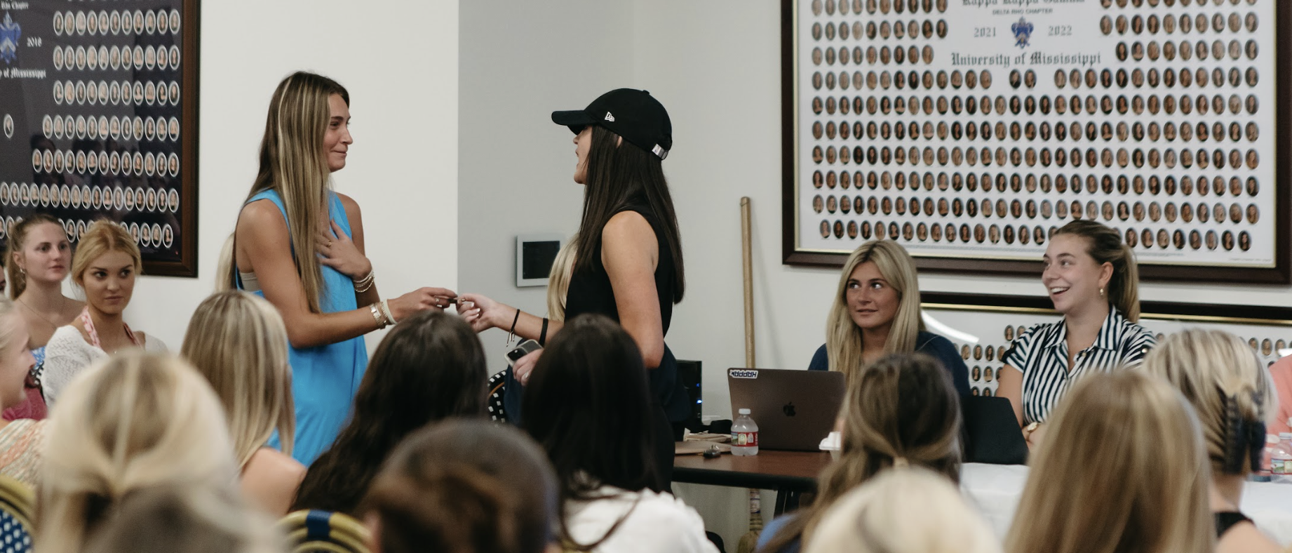 Tonya shaking a young woman