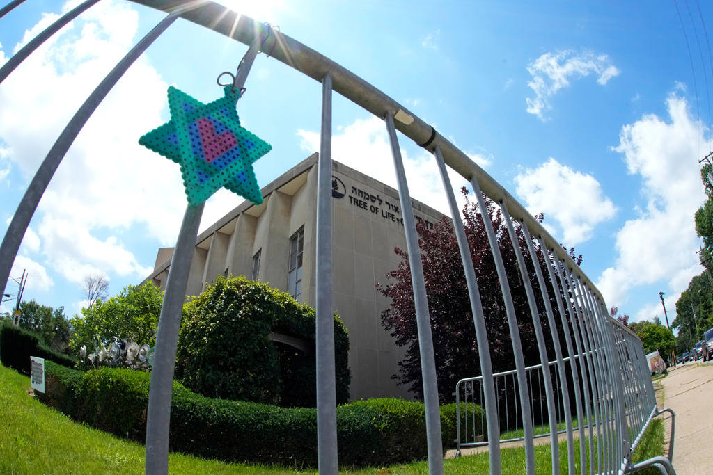 A Star of David hands from a fence outside the dormant landmark Tree of Life synagogue in Pittsburgh