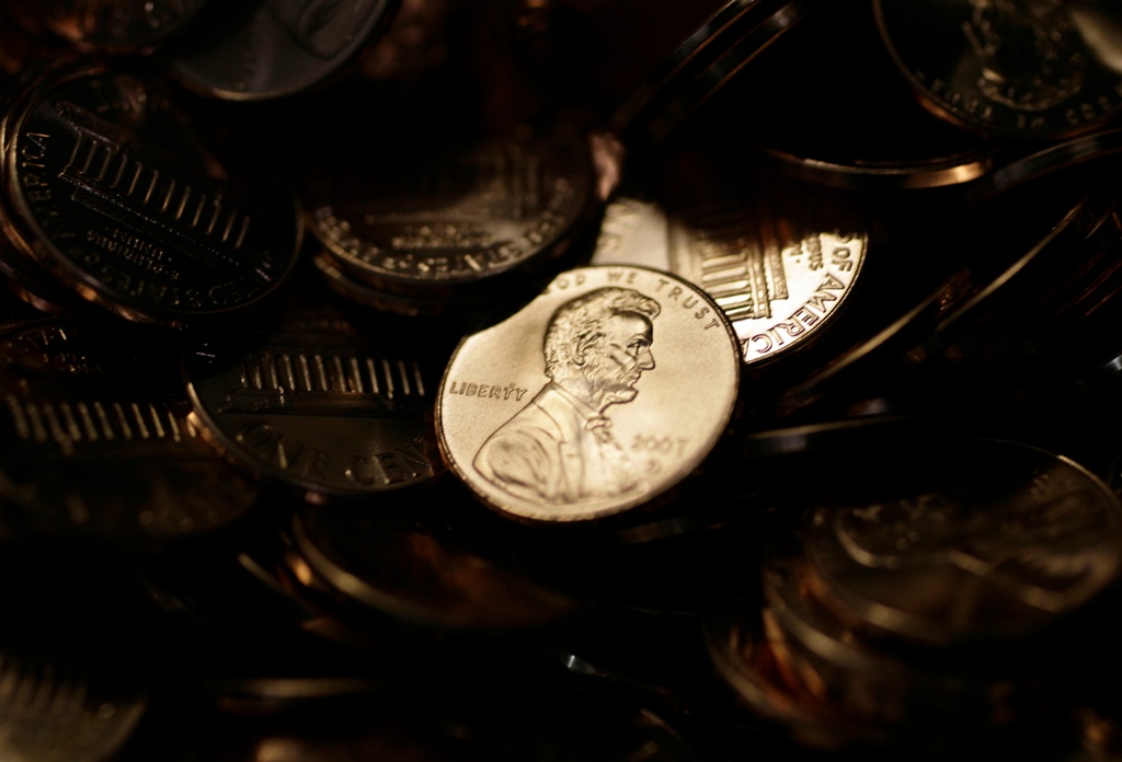 Lone penny is illuminated in a bin of completed pennies at the U.S. Mint in Denver 