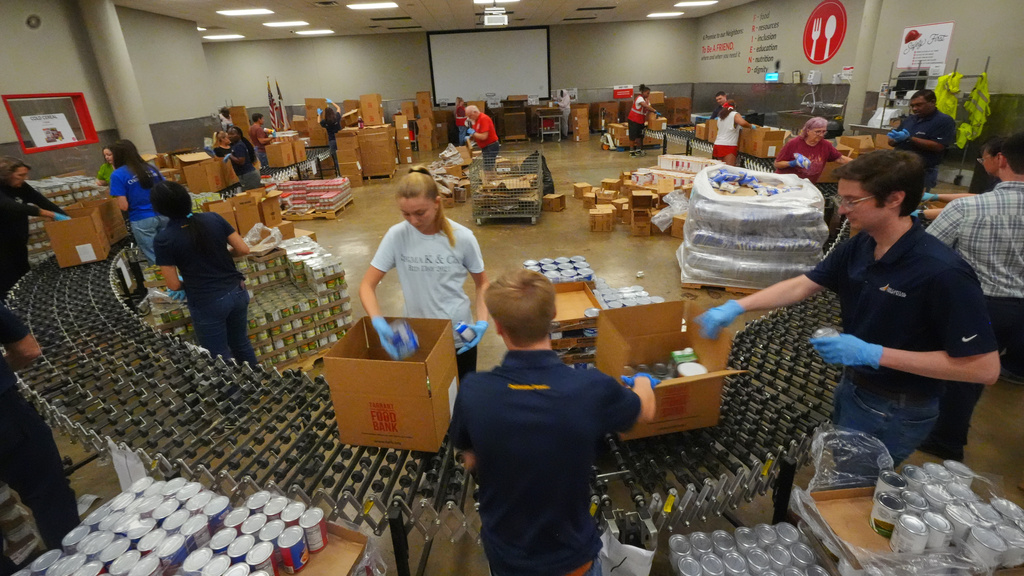 Volunteers prepare emergency food packages at the Tarrant Area Food Bank in Fort Worth, Texas