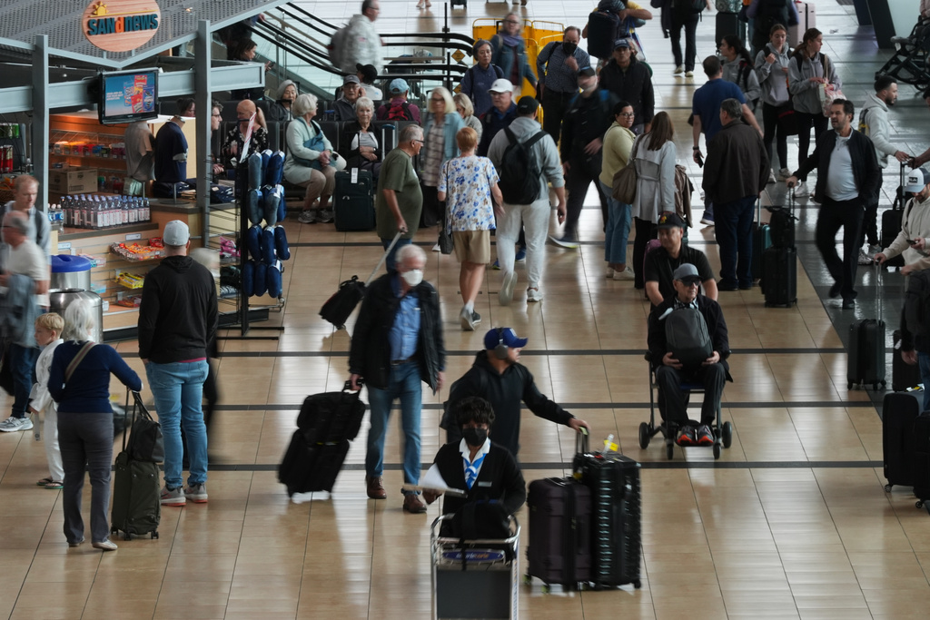 People make their way through a terminal at San Diego International Airport 
