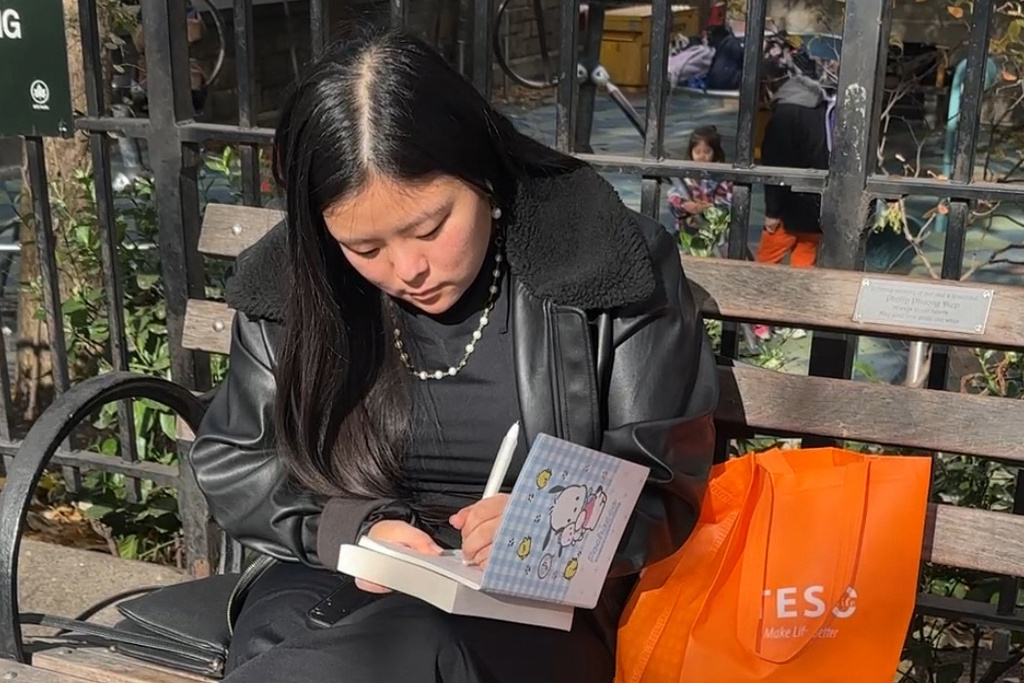 Kim Ventresca, 22, writes in a journal at Union Square Park in Manhattan