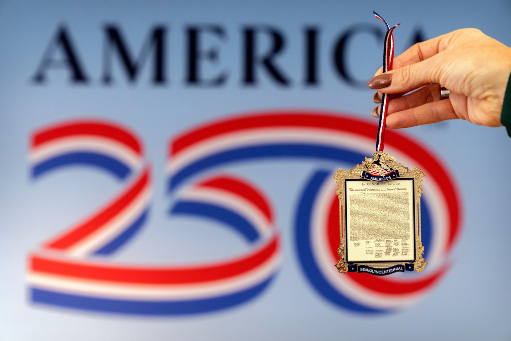 Jennifer Condon, Executive Vice President of America250, displays the front of a commemorative ornament released by America250 as part of events leading up to the 250th anniversary of the signing of the Declaration of Independence in 1776