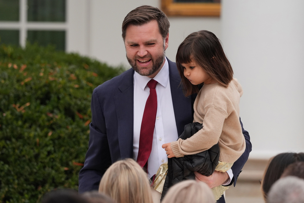 Vice President JD Vance holding his daughter Mirabel, as they take their seat for pardoning ceremony for the national Thanksgiving turkeys Waddle and Gobble
