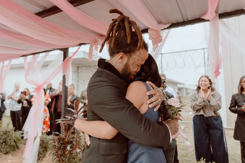 A prisoner at the Louisiana State Penitentiary embracing a loved one before a father-daughter dance 