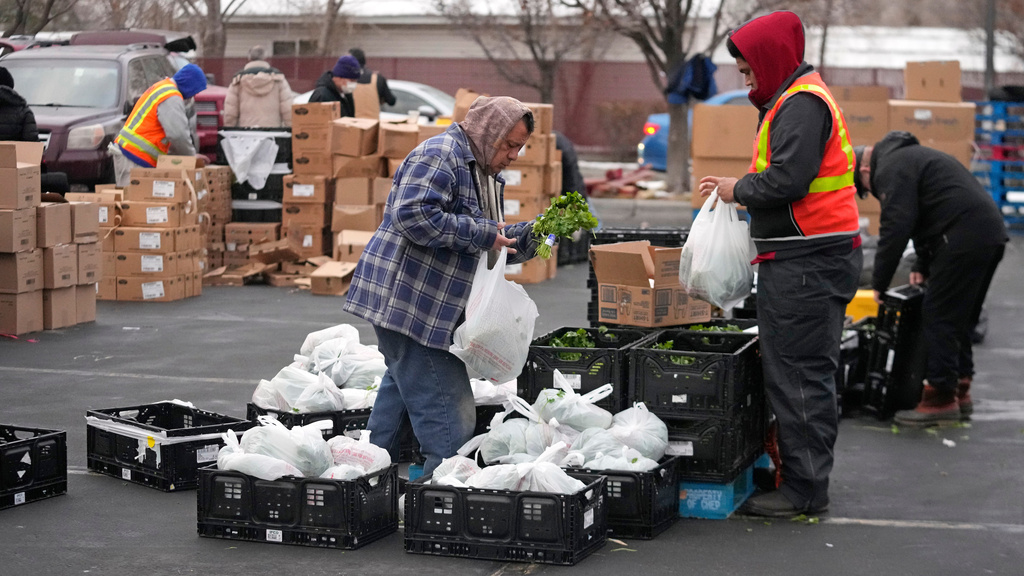  Utah Food Bank volunteers gather groceries for the needy at a mobile food pantry distribution site 