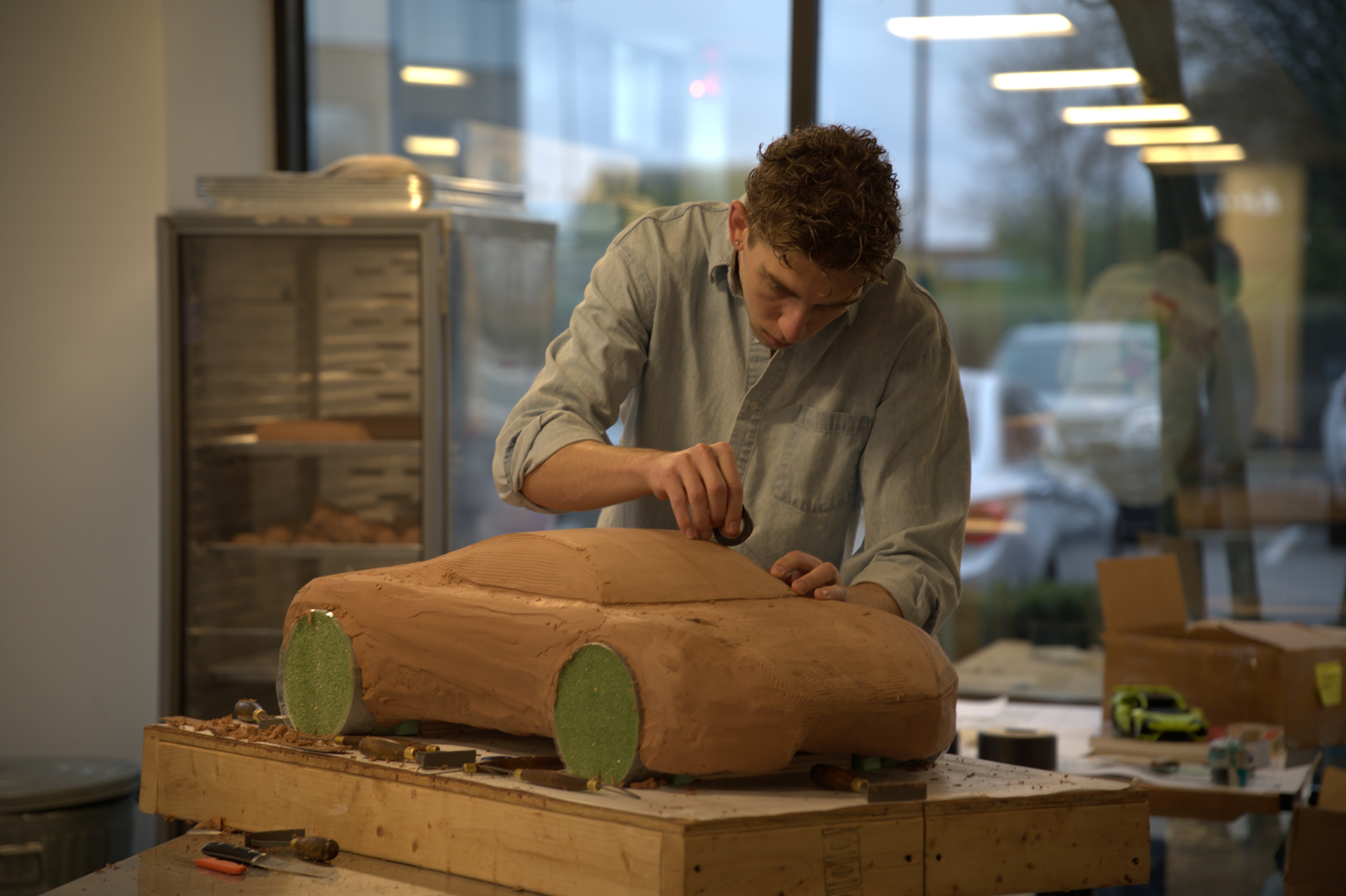 A Cedarville University student carefully constructs a clay model of his team’s design for the 2035 Pony Car