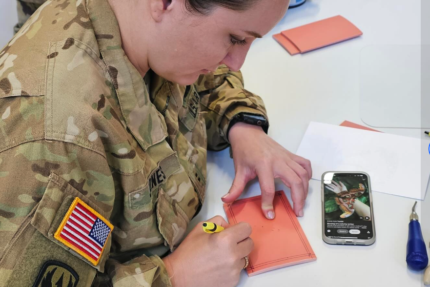 Woman in uniform working on a piece of art