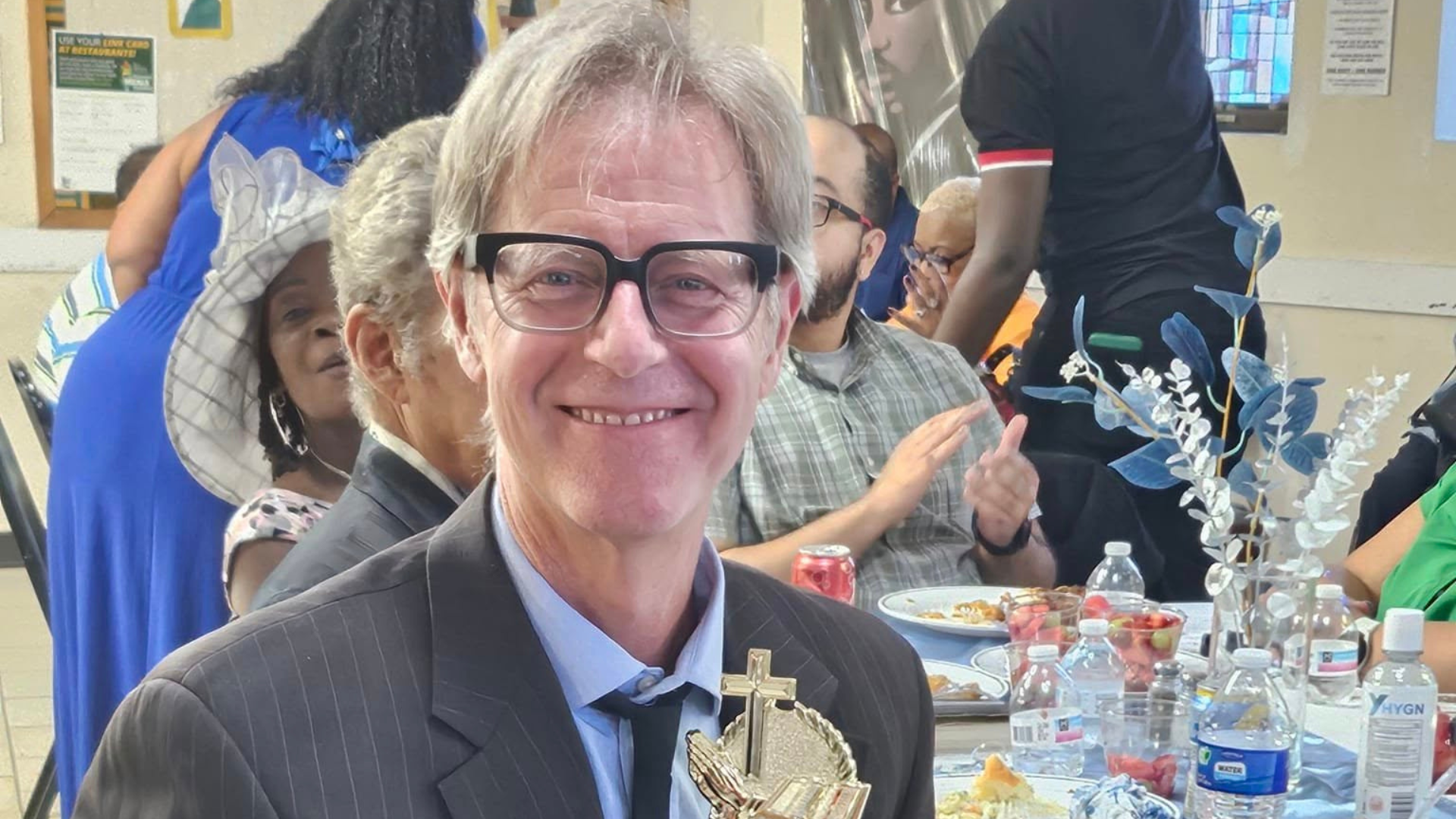 Burnell receives an award from Gorham United Methodist Church, where he played worship piano for 23 years.