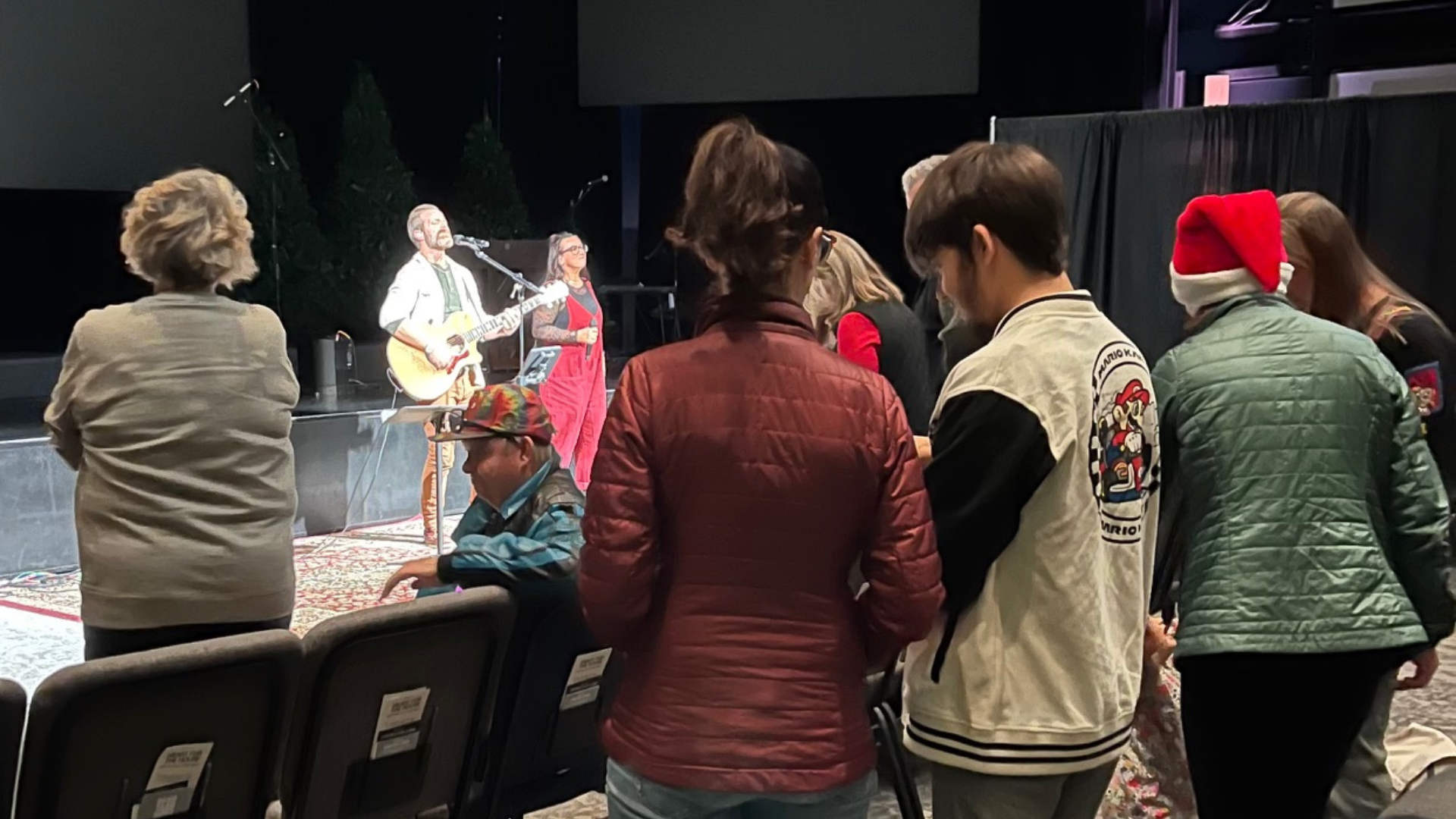 Ian Thomson and his wife lead worship as others join in praise.