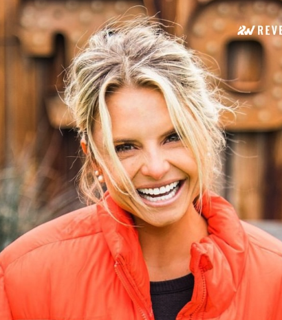 Smiling blond girl with orange vest and black shirt