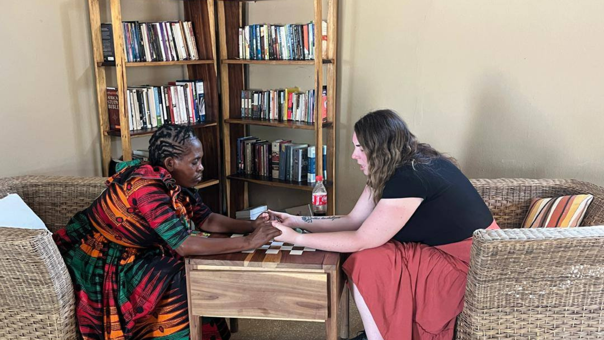 Epperson prays with a sister in Christ during a mission trip to Africa.