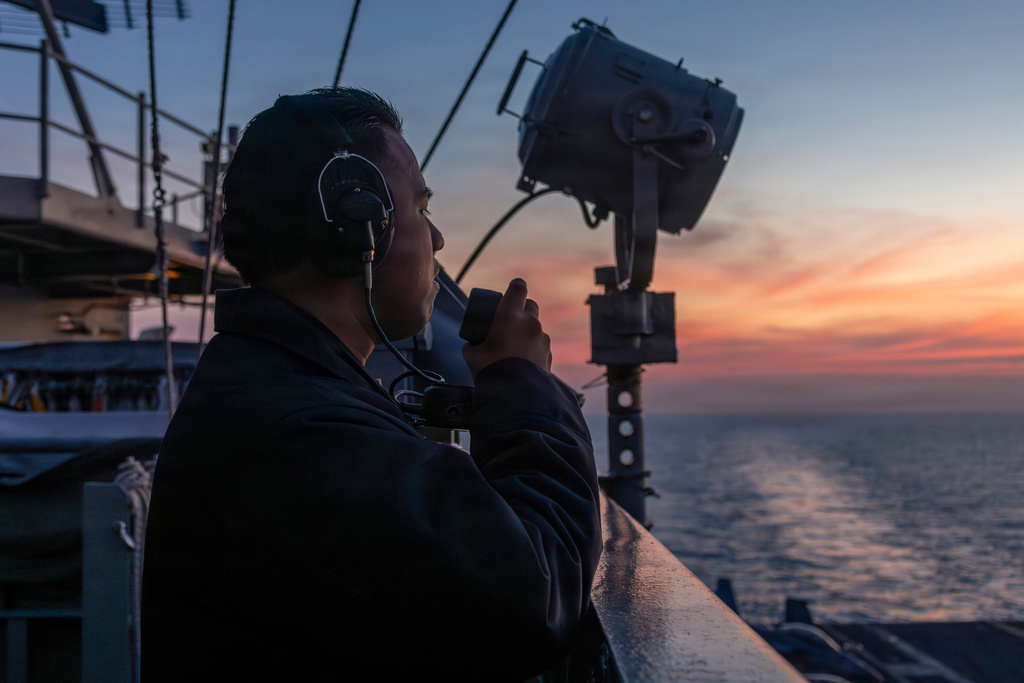 Seaman Rafael Brito standing watch aboard the Nimitz-class aircraft carrier USS Abraham Lincoln in the Indian Ocean
