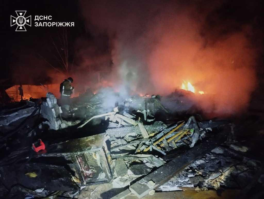 Emergency services personnel work to extinguish a fire following a Russian attack in Zaporizhzhia region, Ukraine
