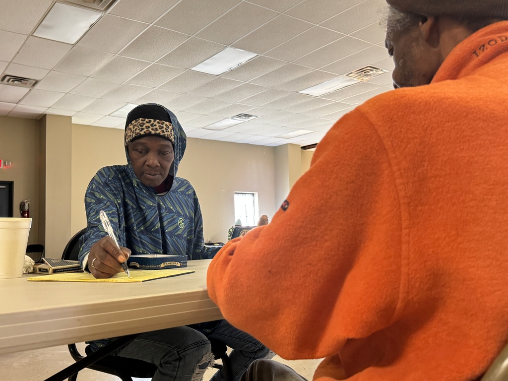 Sherry Miller, who is staying at the Humphreys County warming center, passes the time playing dominoes with others seeking shelter in Belzoni, Miss.,