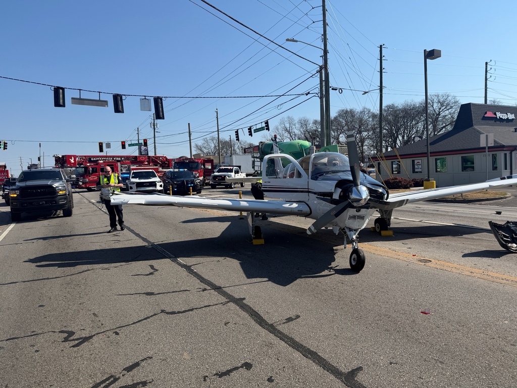 The plane struck three cars, dislodging a fuel tank into one of them