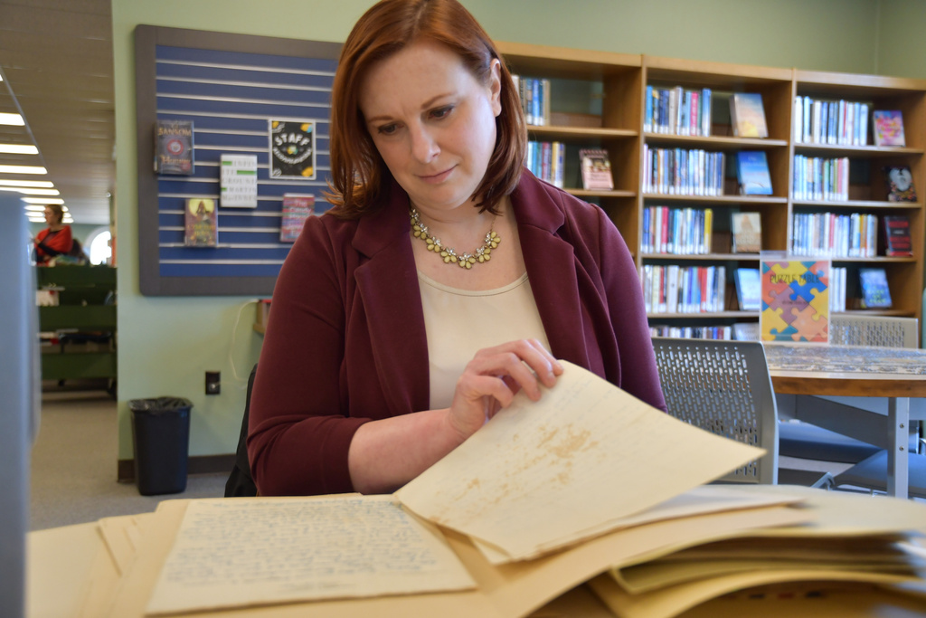Archivist Kelley Sirko looks at love letters between a Black soldier and his wife during World War II that are part of a digital exhibit 