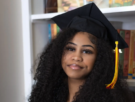 Young woman in cap and gown