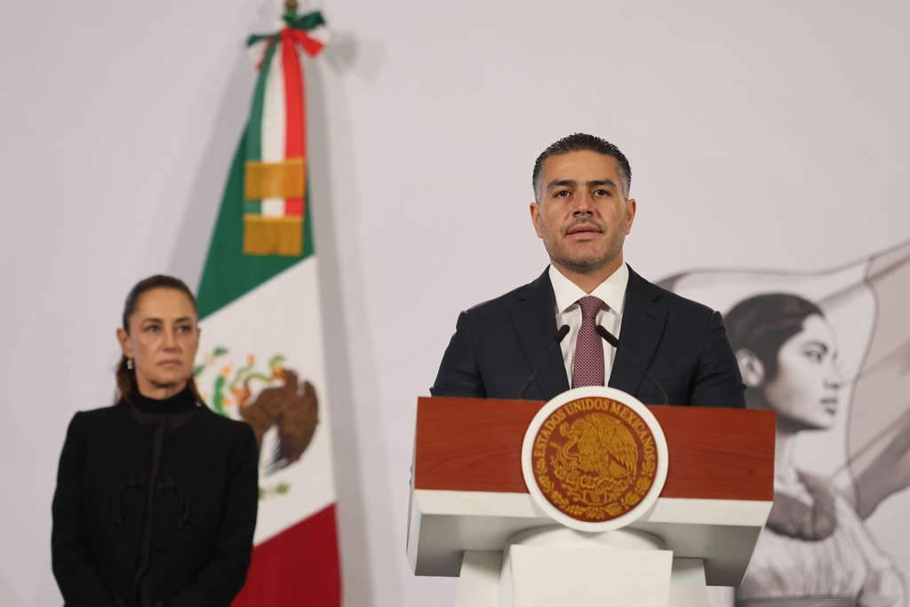 Mexican Security and Citizen Protection Minister Omar Garcia Harfuch speaks as President Claudia Sheinbaum looks on 