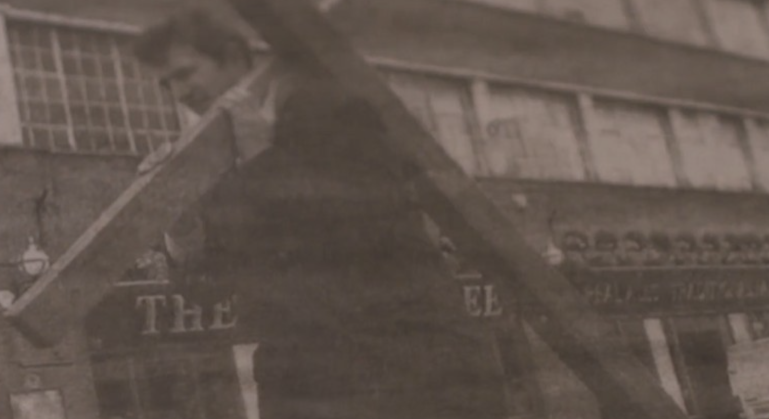 Man carrying huge wooden cross