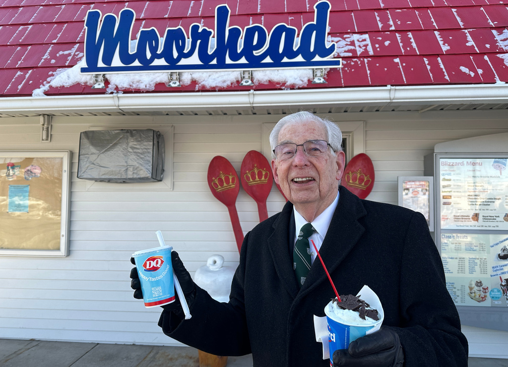 Jerry Protextor heads to his car with ice cream treats for his wife and him at the Dairy Queen in Moorhead, Minn.