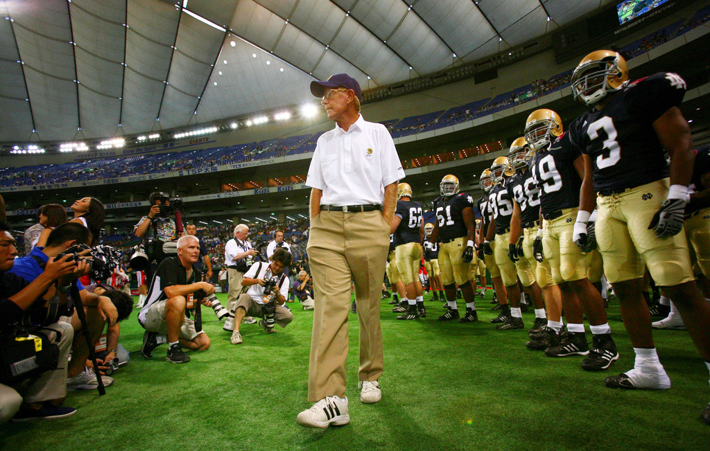 Notre Dame football coach Lou Holtz and his team players await before the start of their game against Japan