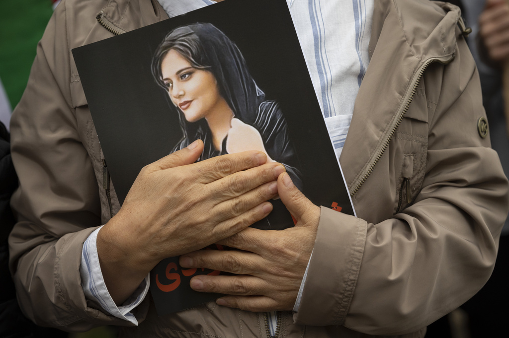 A portrait of Mahsa Amini is held during a rally calling for regime change in Iran following the death of Amini, a young woman who died after being arrested in Tehran by Iran