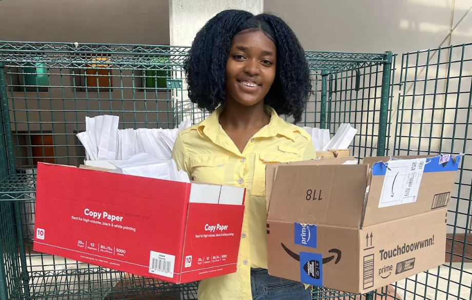 Young woman holding two open boxes