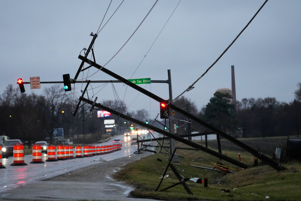 Utility poles are damaged in the aftermath of a powerful storm that ripped through the area a day earlier in Kankakee, Ill.