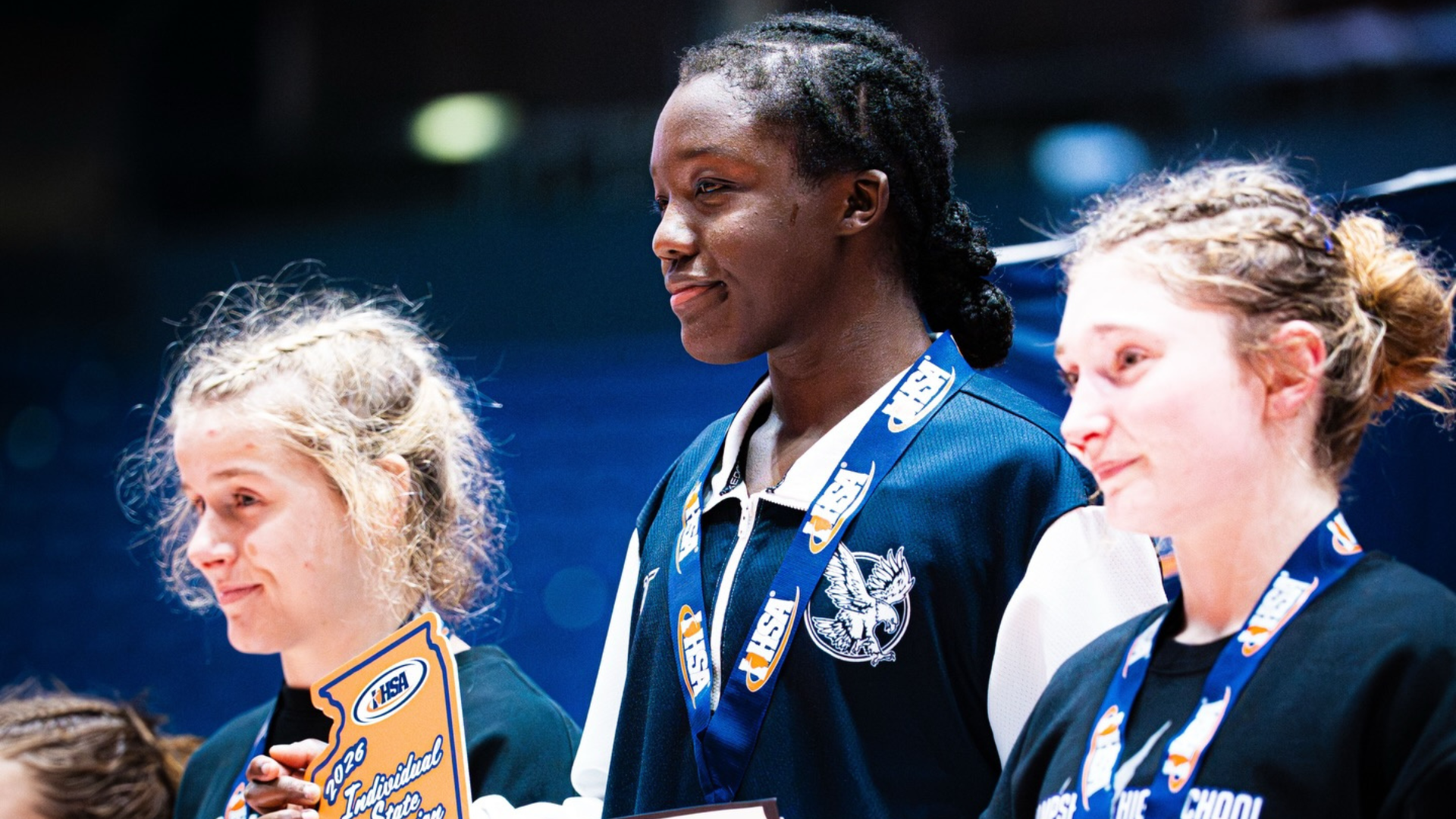 RJ Griffin stands atop the podium as the undefeated 2026 IHSA state champion, the first Beat the Streets Chicago female wrestler to accomplish the feat.