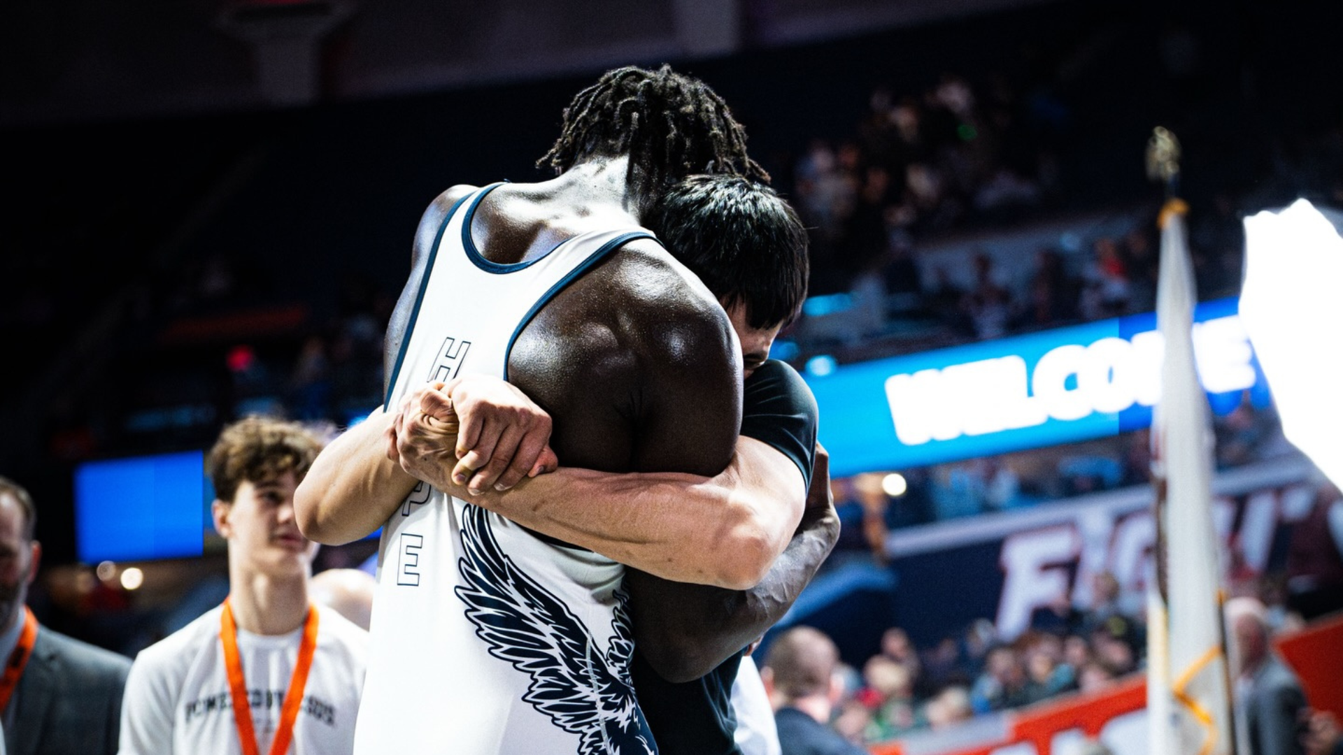 Arkail Griffin celebrates with his coach after winning the 2026 IHSA state championship.