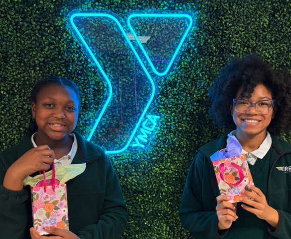 Two girls holding goodie bags