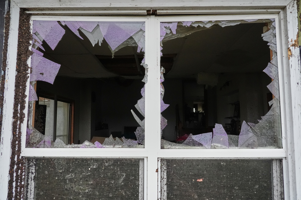 A window is damaged in the aftermath of a powerful storm that ripped through the area a day earlier in Kankakee, Ill.
