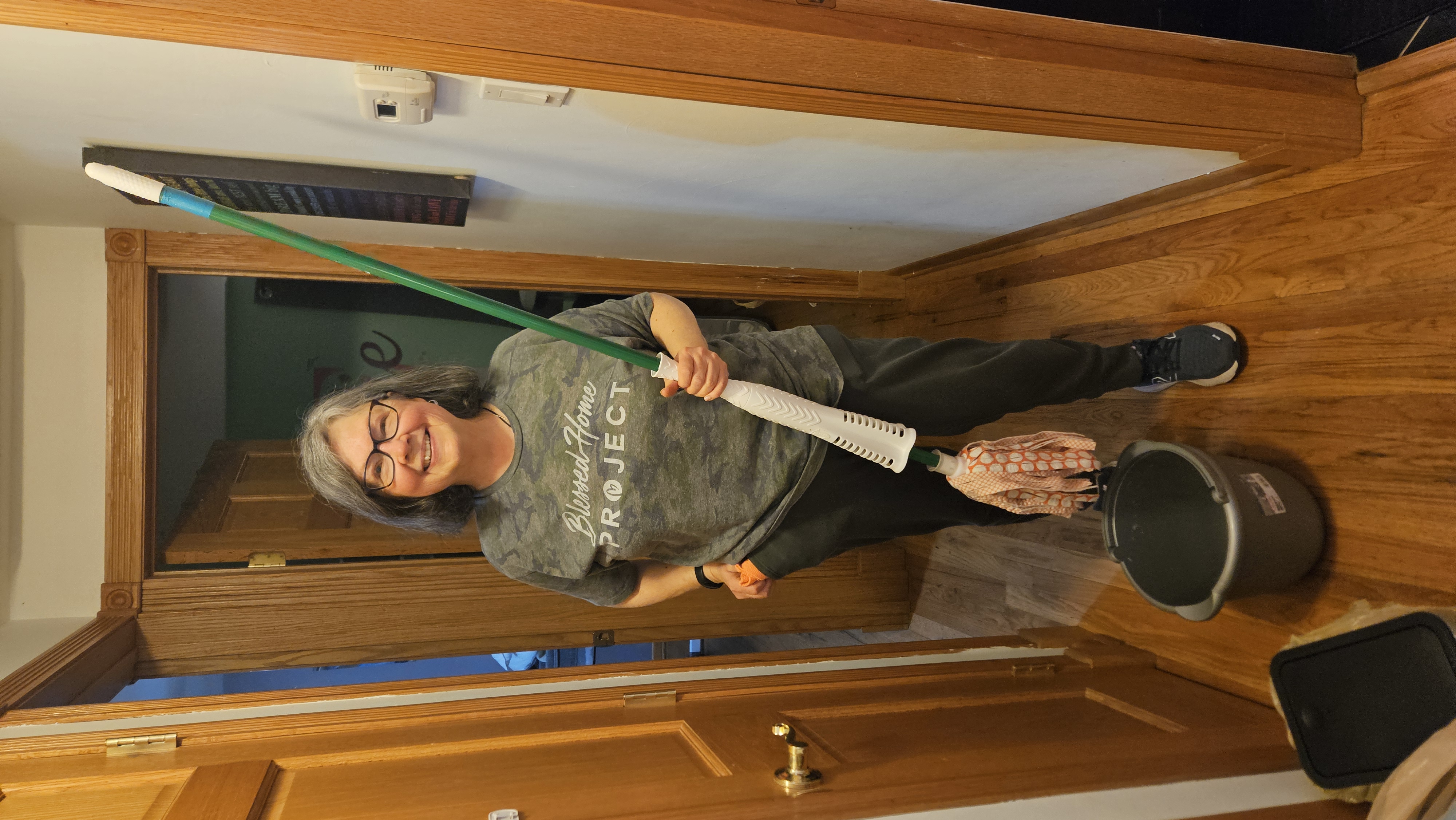 volunteer with mop in hand