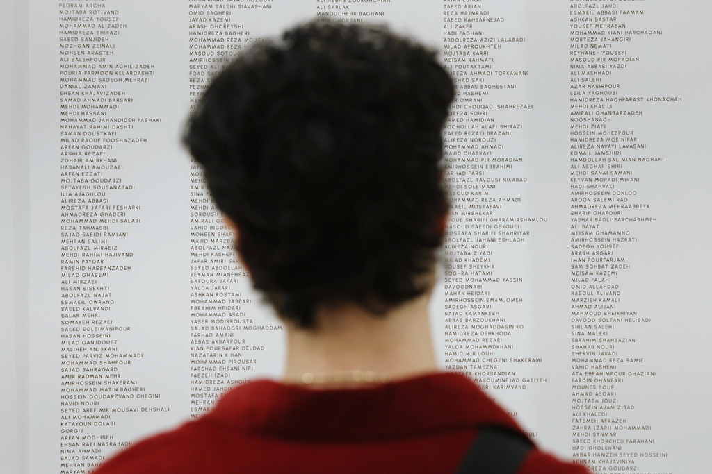 People read the names of Iranian lives that were lost during the Pomexpo Norooz Bazaar 