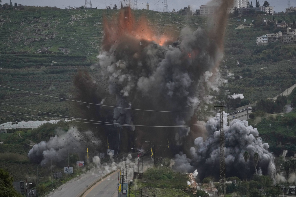 Smoke and flames rise from an Israeli airstrike that hit the Qasmiyeh Bridge near the coastal city of Tyre, Lebanon