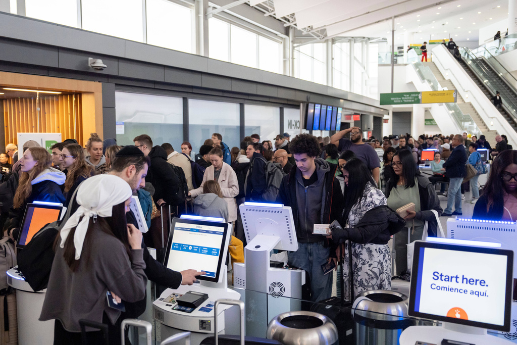 People wait in a TSA line