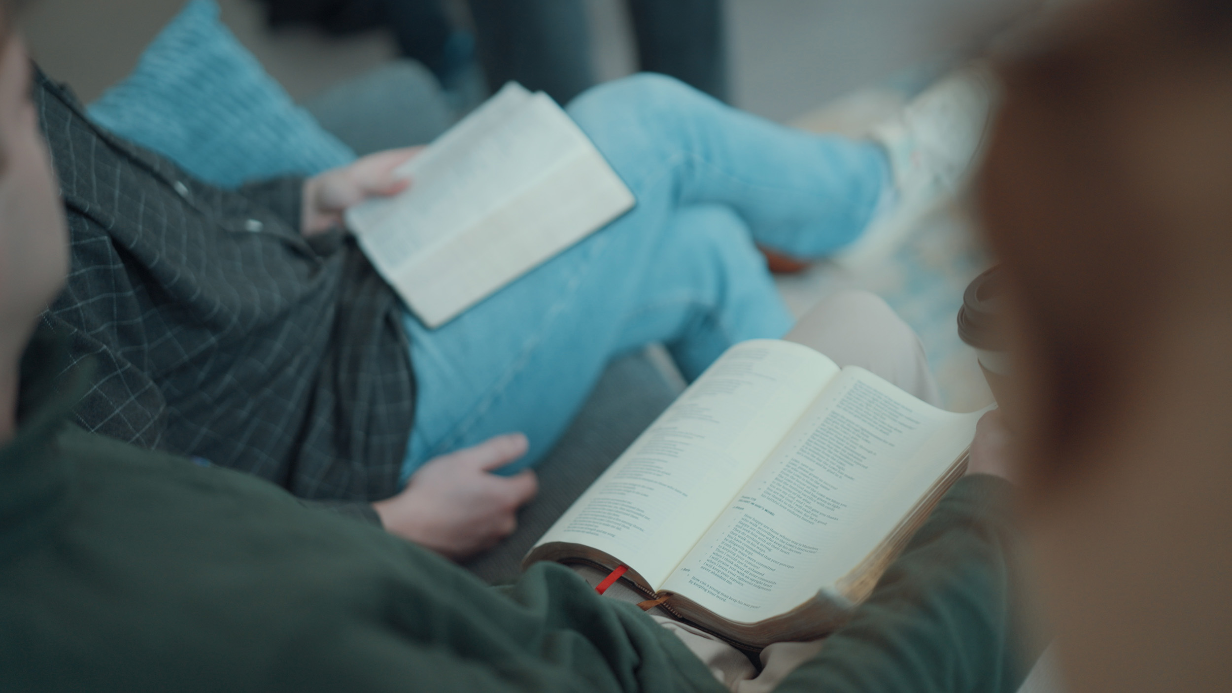 Open Bibles rest on students’ laps during a discussion at Cedarville University